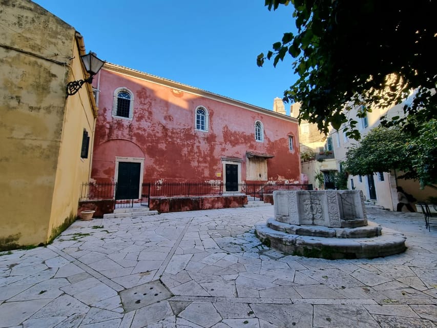 Reading Corfu Through Its Buildings—and the People Who Used Them 3 Quiet square with a Venetian well and red church in the old town
