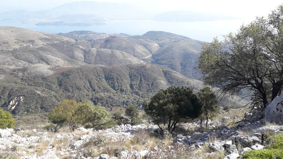 Pantokrator’s Village Road: A Four-Hour Tour with a Guide-Role Conflict 3 Rocky upper slopes of Mount Pantokrator above distant countryside