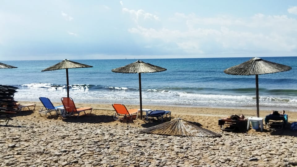 Porto Timoni, Agios Stefanos and Canal d’Amour: Three Beaches, Three Access Problems 2 Sun loungers and straw umbrellas on a broad northern Corfu beach