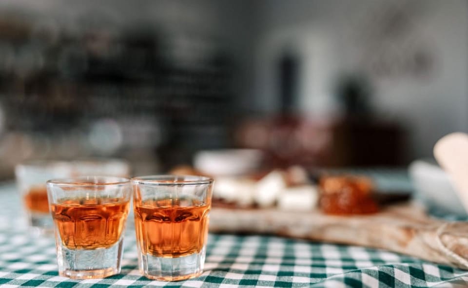 Ten Corfiot Products in One Hour: A Tasting Glossary 3 Two small glasses of amber liqueur beside a Corfiot tasting board