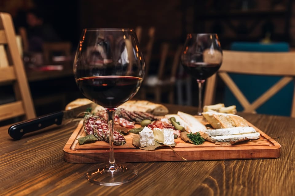 Lefkimmi Family Winery: Follow the Grape from Estate to Three Glasses 3 Red wine served with cheese, bread and cured meat on a tasting board